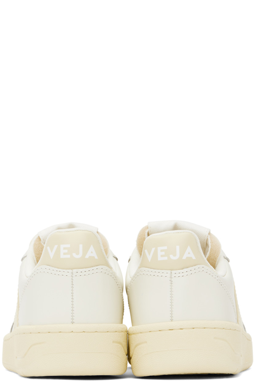 Low-top buffed leather sneakers in off-white.

· Suede trim and perforations at toe
· Lace-up closure
· Logo patch at padded tongue
· Padded collar
· Rubberized logo appliqué at sides
· Logo printed at heel tab
· Recycled polyester jersey lining
· Treaded rubber sole

Supplier color: Pure/Calcaire