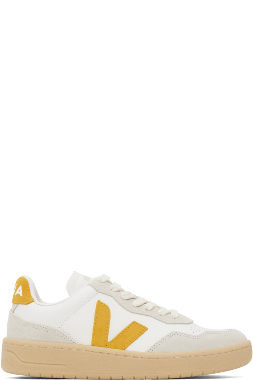 Low-top grained organic leather and suede sneakers in white.

· Suede trim in off-white throughout
· Perforations at toe
· Lace-up closure
· Logo printed at padded tongue
· Padded collar
· Logo appliqué at sides
· Text embossed at outer side
· Logo printed at heel tab
· Recycled polyester jersey lining
· Treaded rubber sole

Supplier color: Extra-white/Toscane/Natural