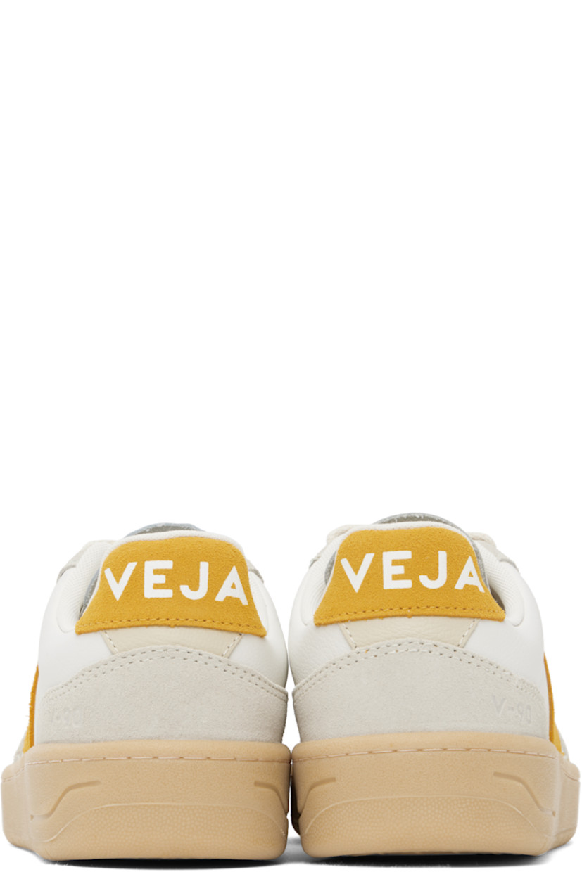 Low-top grained organic leather and suede sneakers in white.

· Suede trim in off-white throughout
· Perforations at toe
· Lace-up closure
· Logo printed at padded tongue
· Padded collar
· Logo appliqué at sides
· Text embossed at outer side
· Logo printed at heel tab
· Recycled polyester jersey lining
· Treaded rubber sole

Supplier color: Extra-white/Toscane/Natural