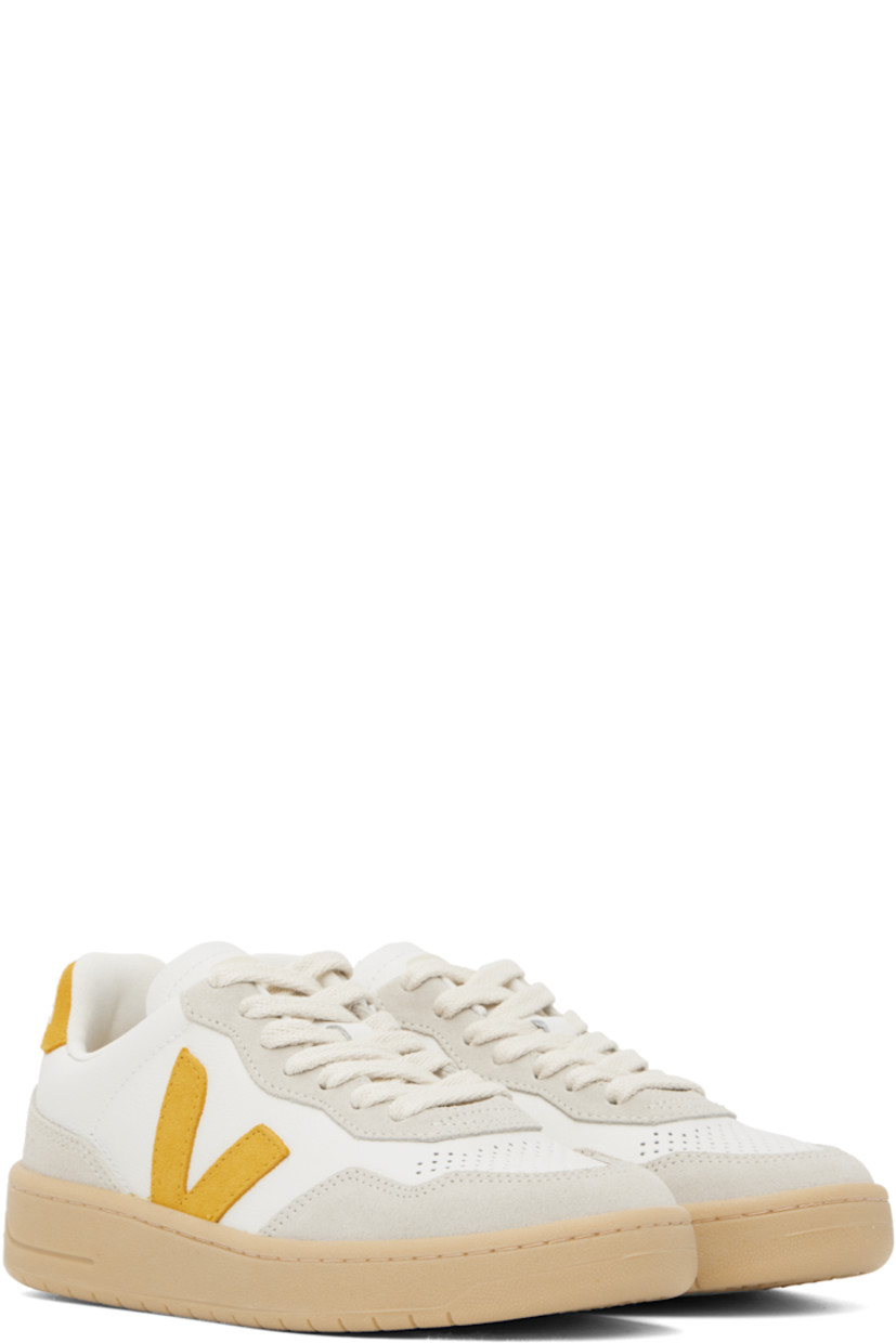 Low-top grained organic leather and suede sneakers in white.

· Suede trim in off-white throughout
· Perforations at toe
· Lace-up closure
· Logo printed at padded tongue
· Padded collar
· Logo appliqué at sides
· Text embossed at outer side
· Logo printed at heel tab
· Recycled polyester jersey lining
· Treaded rubber sole

Supplier color: Extra-white/Toscane/Natural