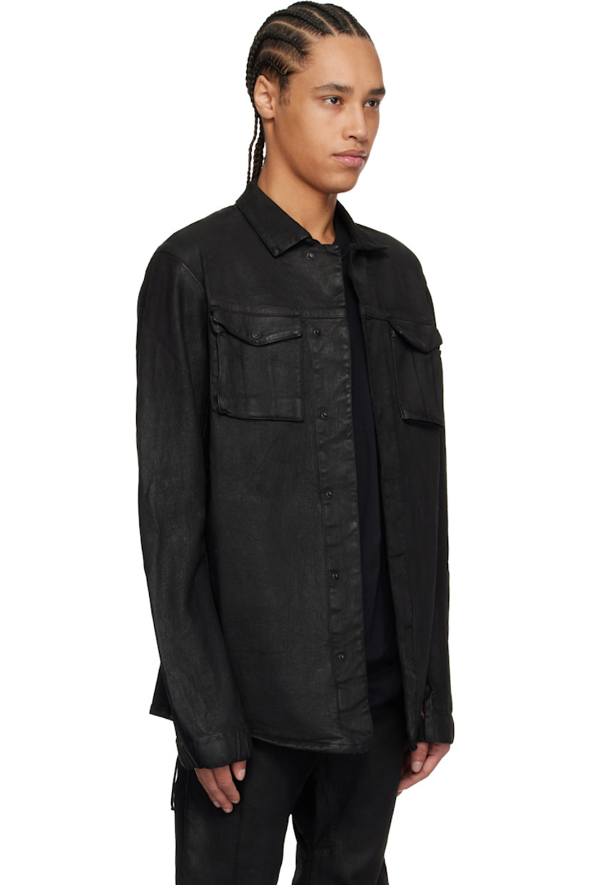 Garment-dyed and coated stretch denim jacket. 

· Spread collar 
· Concealed press-stud closure 
· Flap pockets 
· Seam pockets 
· Curved seam at sleeves 
· Thumbhole at elasticized cuffs 
· Eyelet and extended trim at back 
· Patch pocket at interior 

Supplier color: Black coated