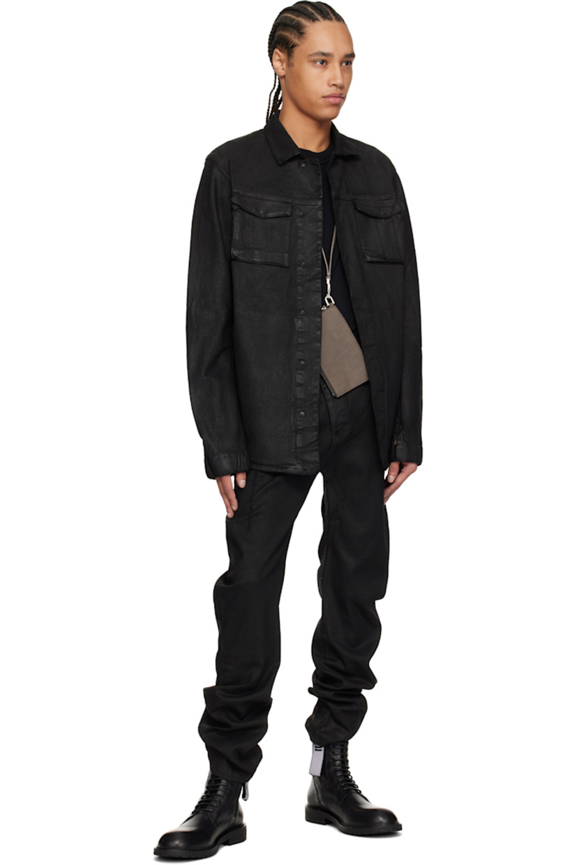 Garment-dyed and coated stretch denim jacket. 

· Spread collar 
· Concealed press-stud closure 
· Flap pockets 
· Seam pockets 
· Curved seam at sleeves 
· Thumbhole at elasticized cuffs 
· Eyelet and extended trim at back 
· Patch pocket at interior 

Supplier color: Black coated