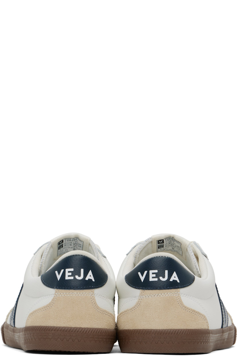 Low-top grained Organic Traced leather and suede sneakers in white and beige.

· Perforated detailing at toe
· Serrated edge at lace-up closure
· Embroidered logo patch at tongue
· Padded tongue and collar
· Logo appliqué at sides
· Logo printed at heel tab
· Recycled mesh lining
· Textured rubber midsole
· Treaded rubber sole

Supplier color: White/Nautico/Bark