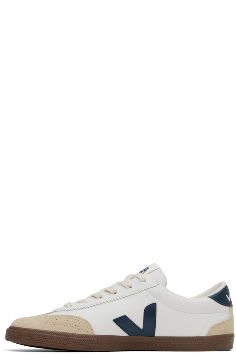 Low-top grained Organic Traced leather and suede sneakers in white and beige.

· Perforated detailing at toe
· Serrated edge at lace-up closure
· Embroidered logo patch at tongue
· Padded tongue and collar
· Logo appliqué at sides
· Logo printed at heel tab
· Recycled mesh lining
· Textured rubber midsole
· Treaded rubber sole

Supplier color: White/Nautico/Bark