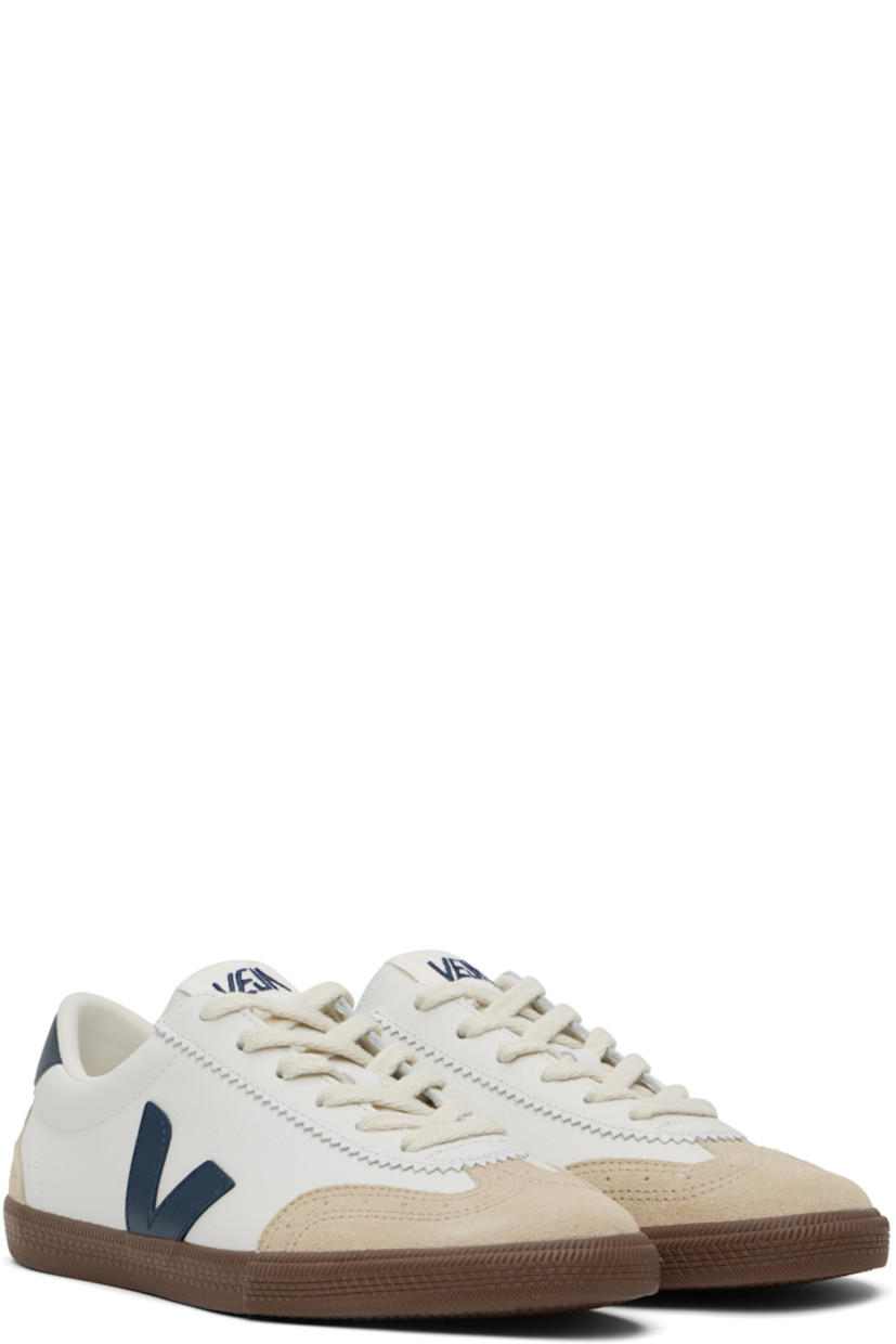 Low-top grained Organic Traced leather and suede sneakers in white and beige.

· Perforated detailing at toe
· Serrated edge at lace-up closure
· Embroidered logo patch at tongue
· Padded tongue and collar
· Logo appliqué at sides
· Logo printed at heel tab
· Recycled mesh lining
· Textured rubber midsole
· Treaded rubber sole

Supplier color: White/Nautico/Bark
