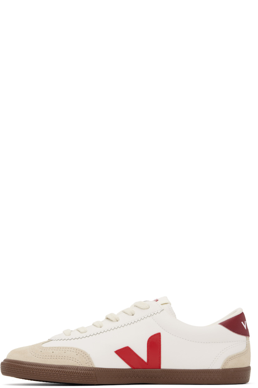 Low-top grained organic leather and suede sneakers in white. 

· Perforated detailing at toe
· Serrated trim at lace-up closure
· Logo patch at padded tongue
· Padded collar
· Logo appliqué at sides
· Logo printed at heel tab
· Recycled polyester jersey lining
· Treaded rubber sole

Supplier color: White/Pekin/Bark