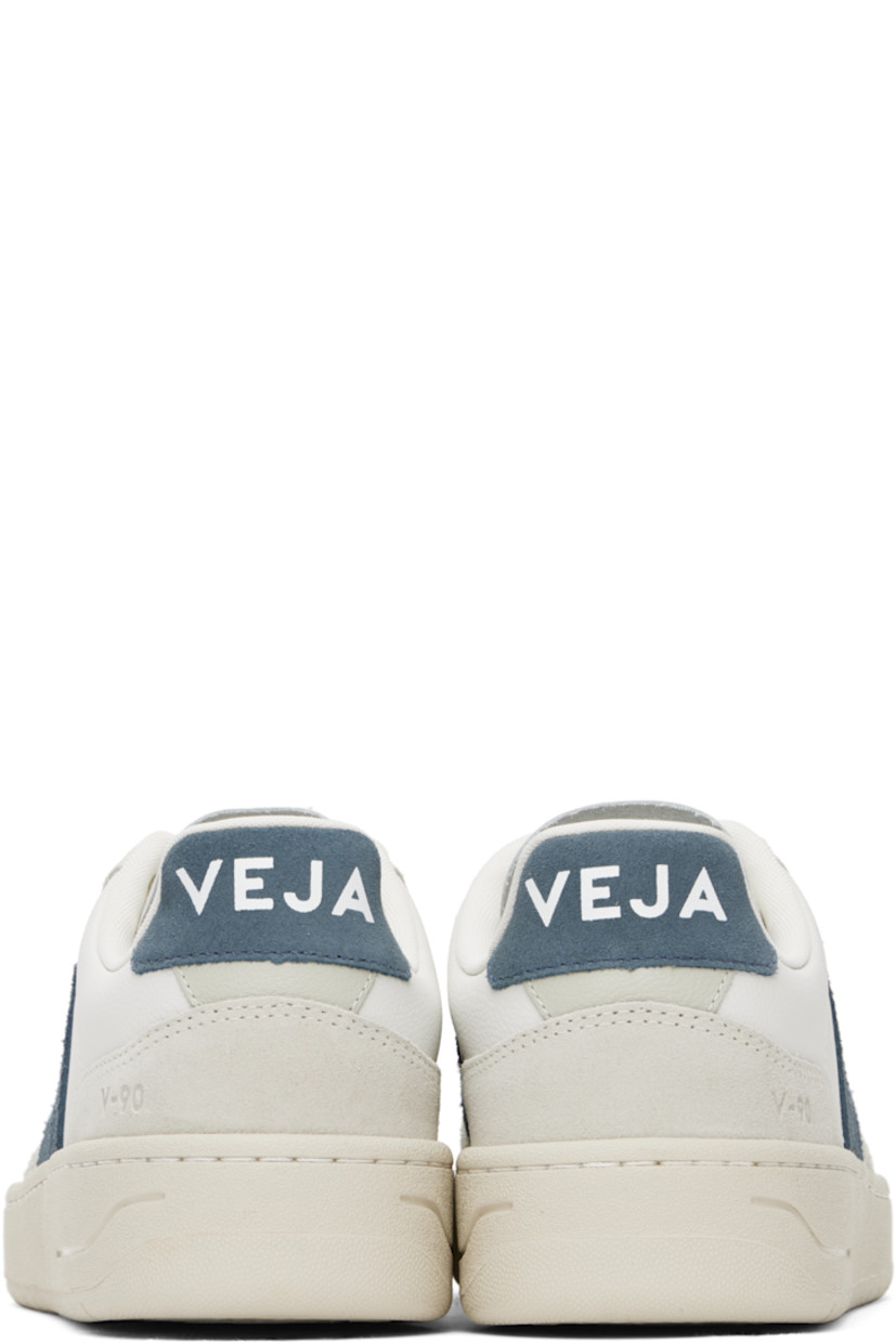 Low-top suede and grained organic leather sneakers in white and gray.

· Perforations at toe
· Lace-up closure
· Logo printed at padded tongue
· Padded collar
· Logo appliqué at sides
· Text embossed at outer side
· Logo printed at heel tab
· Recycled polyester jersey lining
· Treaded rubber sole

Supplier color: Extra-white/California