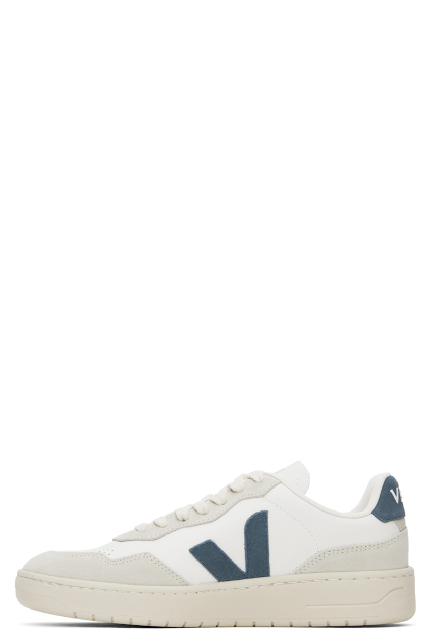 Low-top suede and grained organic leather sneakers in white and gray.

· Perforations at toe
· Lace-up closure
· Logo printed at padded tongue
· Padded collar
· Logo appliqué at sides
· Text embossed at outer side
· Logo printed at heel tab
· Recycled polyester jersey lining
· Treaded rubber sole

Supplier color: Extra-white/California