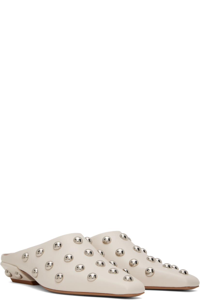Grained calfskin slip-on loafers in beige.  

· Studs throughout
· Pointed square toe 
· Logo stamp at padded footbed
· Grained leather lining 
· Block heel with rubber injection
· Leather sole 
· Silver-tone hardware
· Heel: H1"

Supplier color: Milk