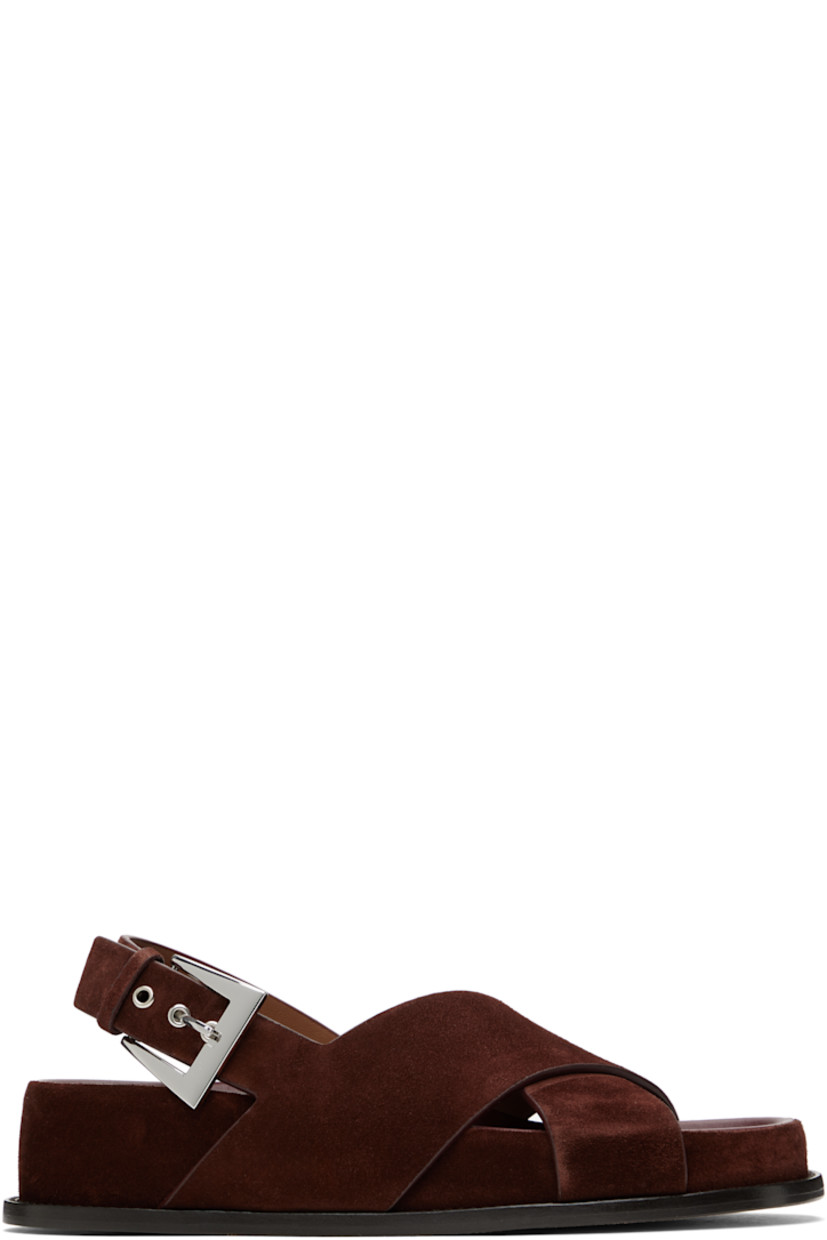 Calfskin suede flat sandals in brown.

· Open toe
· Crisscrossing straps at vamp
· Pin-buckle slingback strap
· Logo-embossed molded leather footbed
· Covered midsole and heel
· Nubuck sole with rubber injection
· Heel: H1.75"

Supplier color: Mogano
