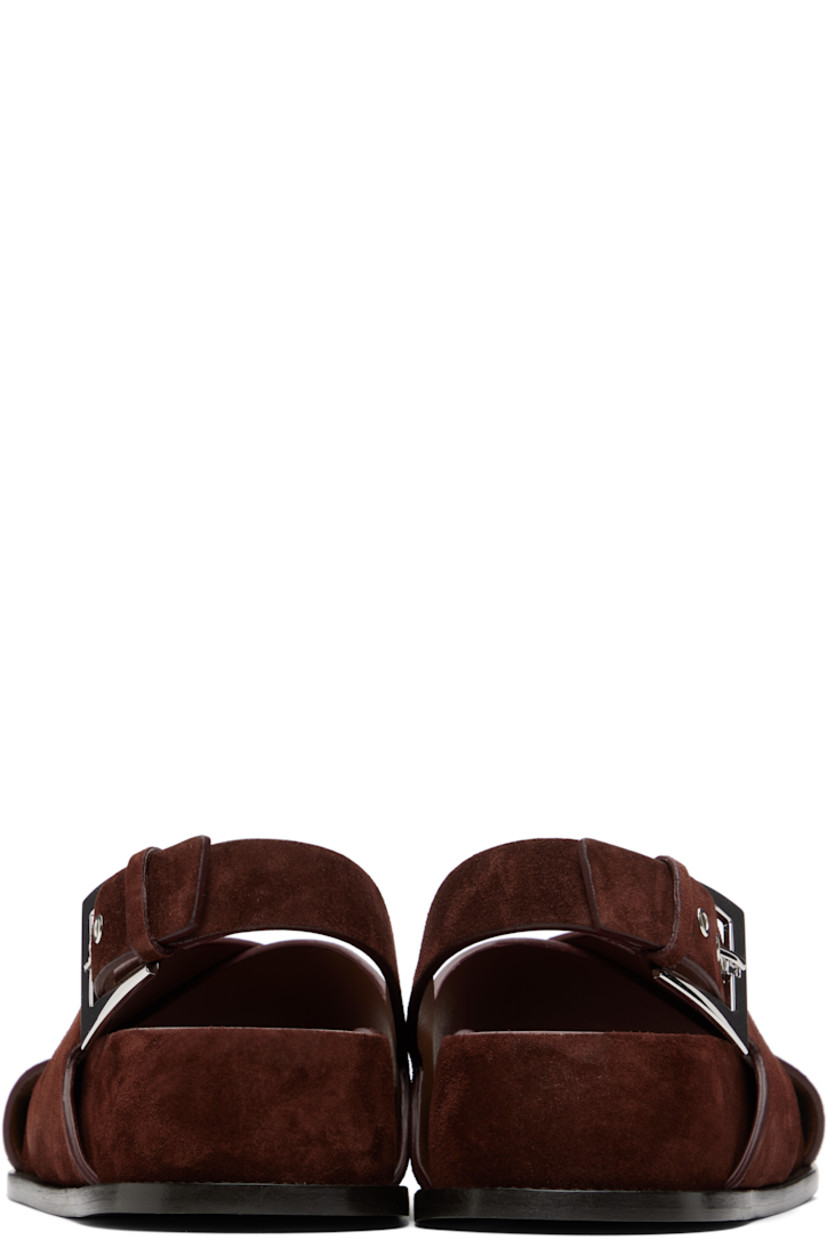 Calfskin suede flat sandals in brown.

· Open toe
· Crisscrossing straps at vamp
· Pin-buckle slingback strap
· Logo-embossed molded leather footbed
· Covered midsole and heel
· Nubuck sole with rubber injection
· Heel: H1.75"

Supplier color: Mogano