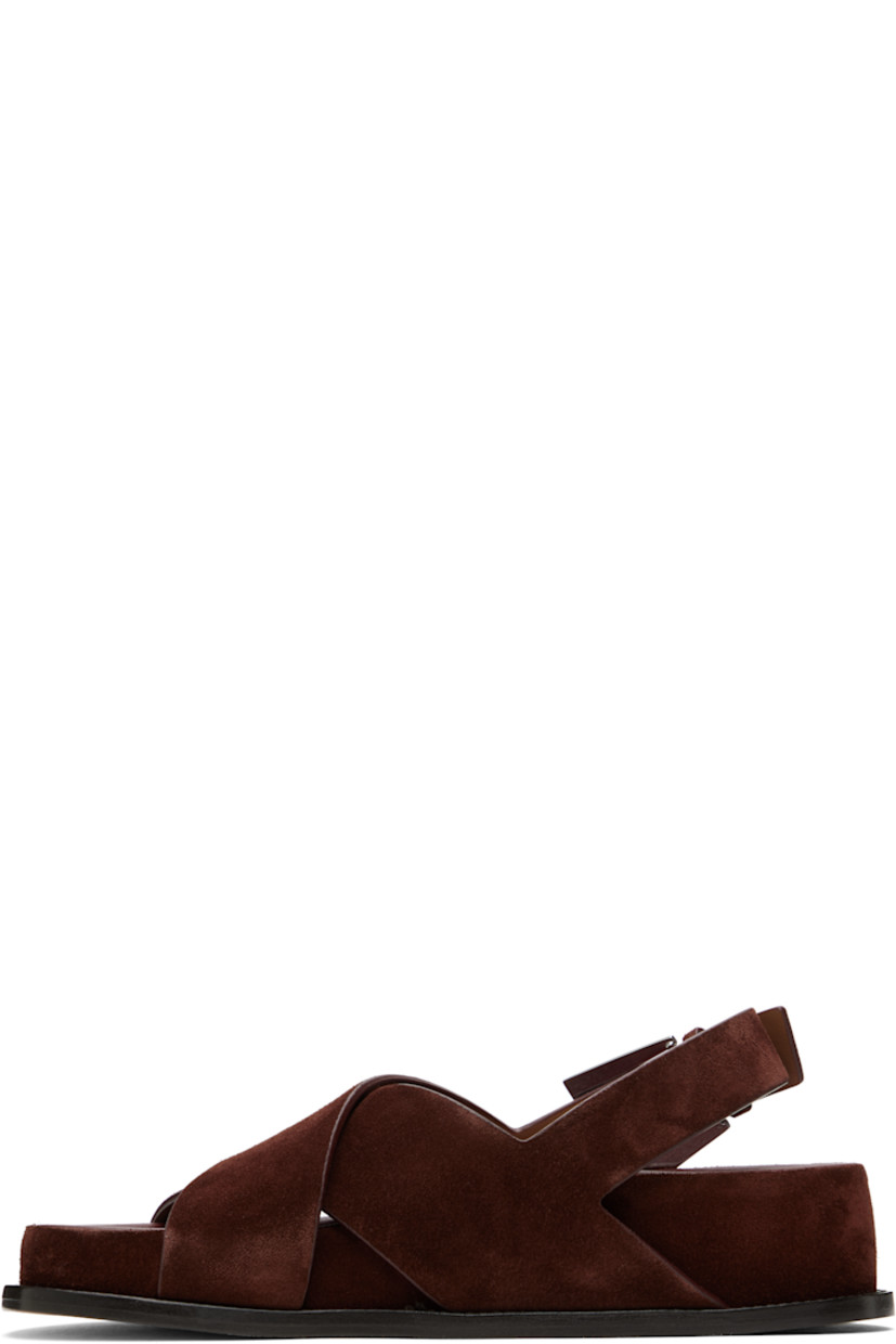 Calfskin suede flat sandals in brown.

· Open toe
· Crisscrossing straps at vamp
· Pin-buckle slingback strap
· Logo-embossed molded leather footbed
· Covered midsole and heel
· Nubuck sole with rubber injection
· Heel: H1.75"

Supplier color: Mogano