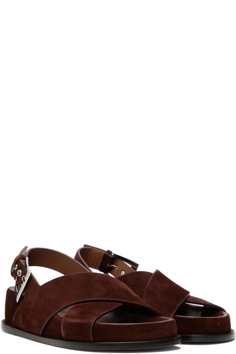 Calfskin suede flat sandals in brown.

· Open toe
· Crisscrossing straps at vamp
· Pin-buckle slingback strap
· Logo-embossed molded leather footbed
· Covered midsole and heel
· Nubuck sole with rubber injection
· Heel: H1.75"

Supplier color: Mogano