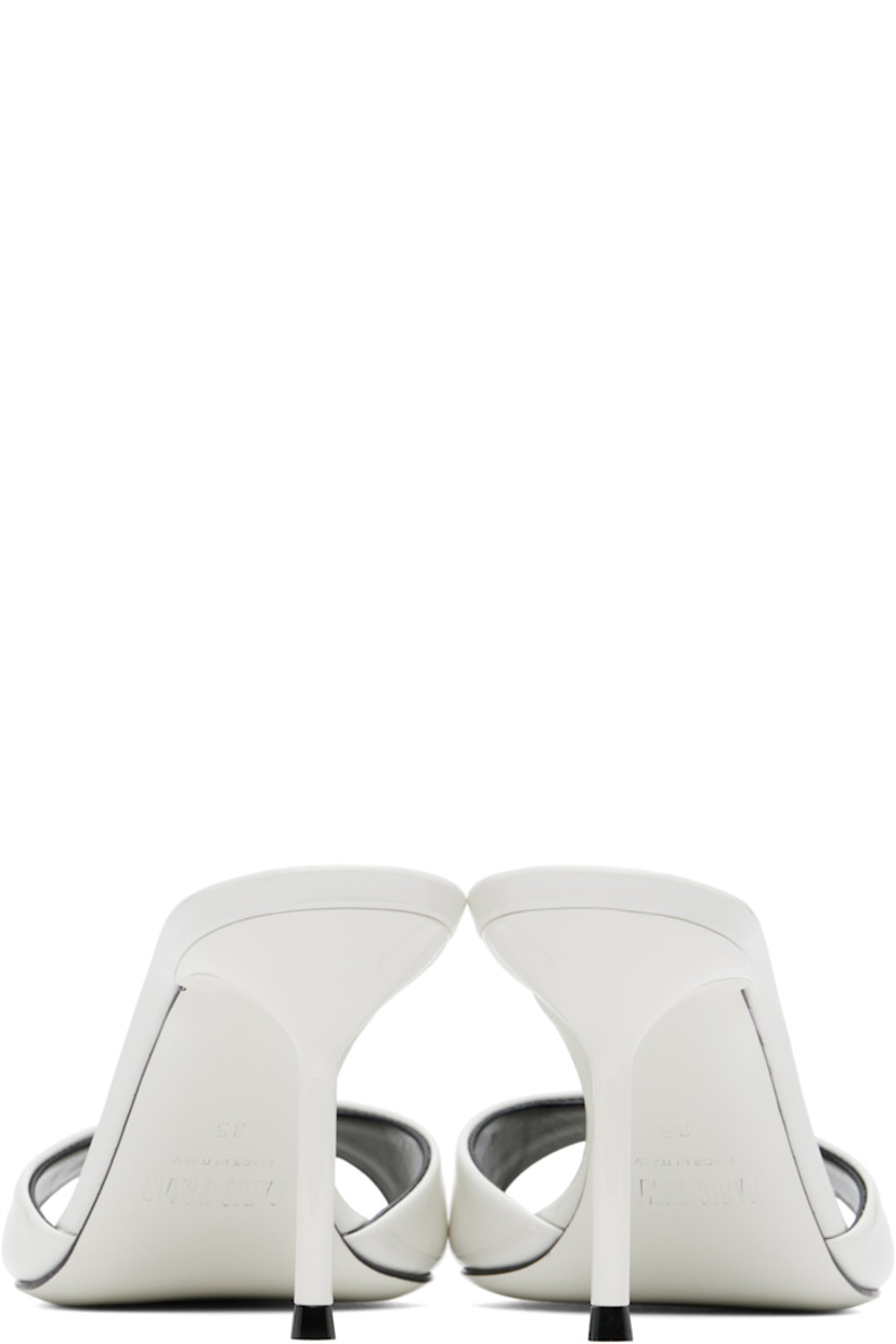 Patent leather mules in white.

· Open toe
· Strap at vamp
· Logo stamp at padded leather footbed
· Metal stiletto heel with rubber injection
· Patent leather sole
· Heel: H3"

Supplier color: White
