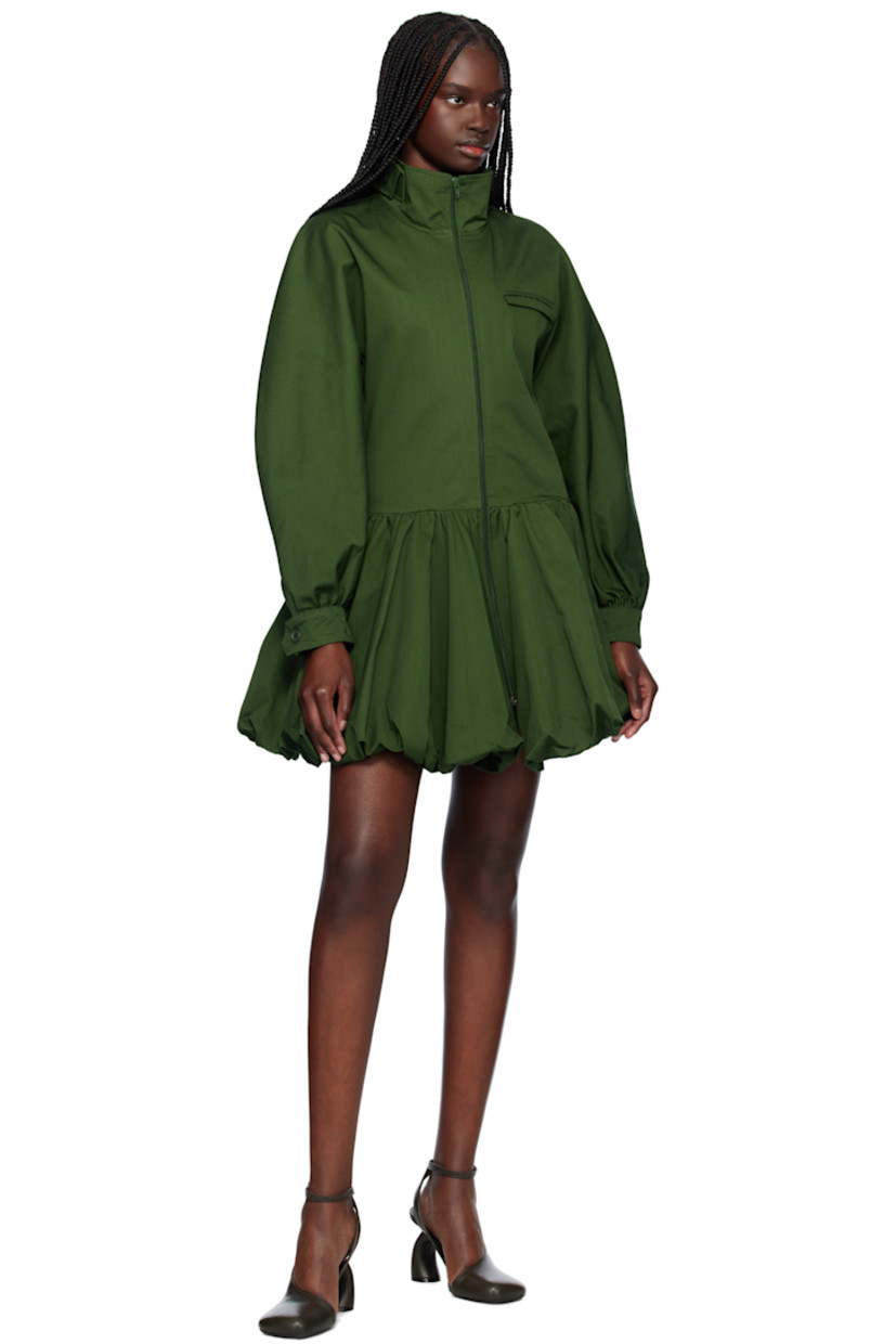 Hand-dyed cotton gabardine minidress. 

· Button tab at stand collar
· Zip closure
· Flap pocket at chest
· Gathering at dropped waist  
· Elasticized bubble hem
· Seam pockets at waist
· Single-button barrel cuffs
· Full plain-woven lining

Supplier color: Green