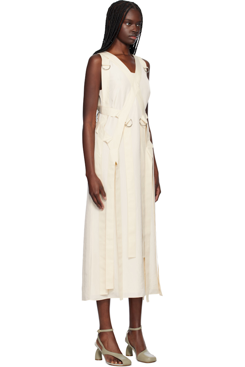 Polyester crinkled satin maxi dress. Detachable canvas harness-style overlay with D-rings. 

· Scoop neck
· Darts at chest
· Concealed zip closure at back 
· Central vent at back hem 
· Full crêpe lining

Supplier color: Cream