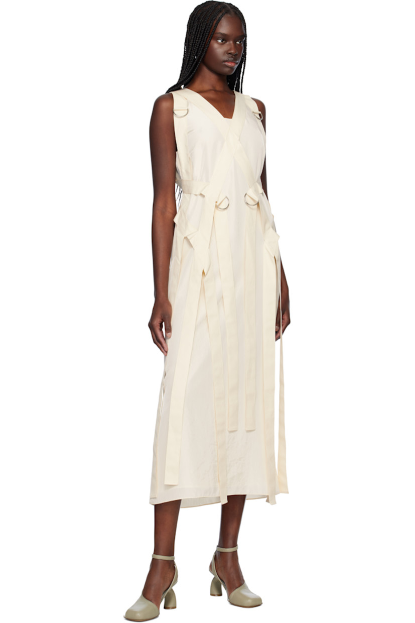 Polyester crinkled satin maxi dress. Detachable canvas harness-style overlay with D-rings. 

· Scoop neck
· Darts at chest
· Concealed zip closure at back 
· Central vent at back hem 
· Full crêpe lining

Supplier color: Cream