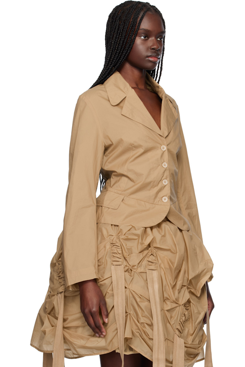 Crinkled double-faced nylon taffeta blazer. 

· Notched lapel
· Button closure
· Mock flap pockets at outseams
· Webbing trim at back sleeves
· Central vent at back hem 
· Unlined

Supplier color: Beige