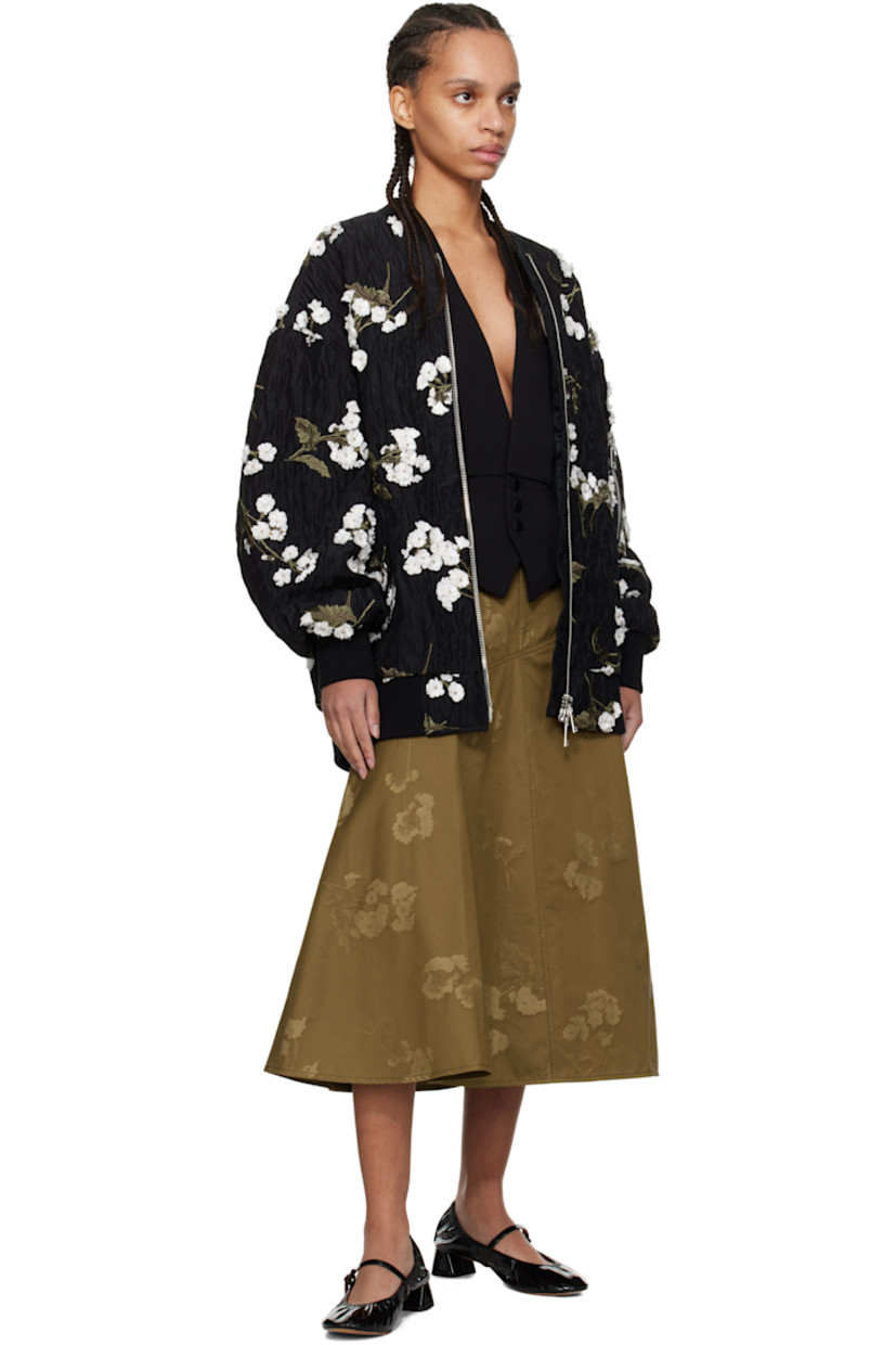 Cotton twill midi skirt. Jacquard floral pattern throughout.

· Paneled construction 
· Belt loops
· Two-pocket styling
· Zip-fly
· Asymmetric hem 
· Draping at side seam

Supplier color: Khaki
