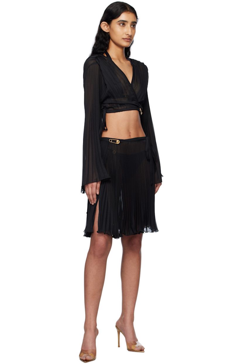 Semi-sheer garment-pleated polyester chiffon cover-up top.

· Plunging V-neck
· Medusa safety pin and self-tie fastening at front
· Cropped hem
· Flared sleeves

Supplier color: Black