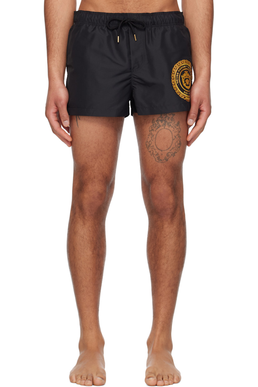 Polyester taffeta swim shorts. 

· Drawstring at elasticized waistband
· Three-pocket styling
· Mock fly
· Logo graphic bonded at front
· Integrated brief-style mesh lining

Supplier color: Black/Gold