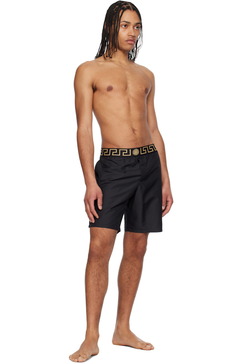 Tapered straight-leg polyester faille swim shorts. 

· Jacquard Greca pattern at elasticized waistband
· Two-pocket styling 
· Mock fly
· Integrated brief-style jersey lining

Supplier color: Black