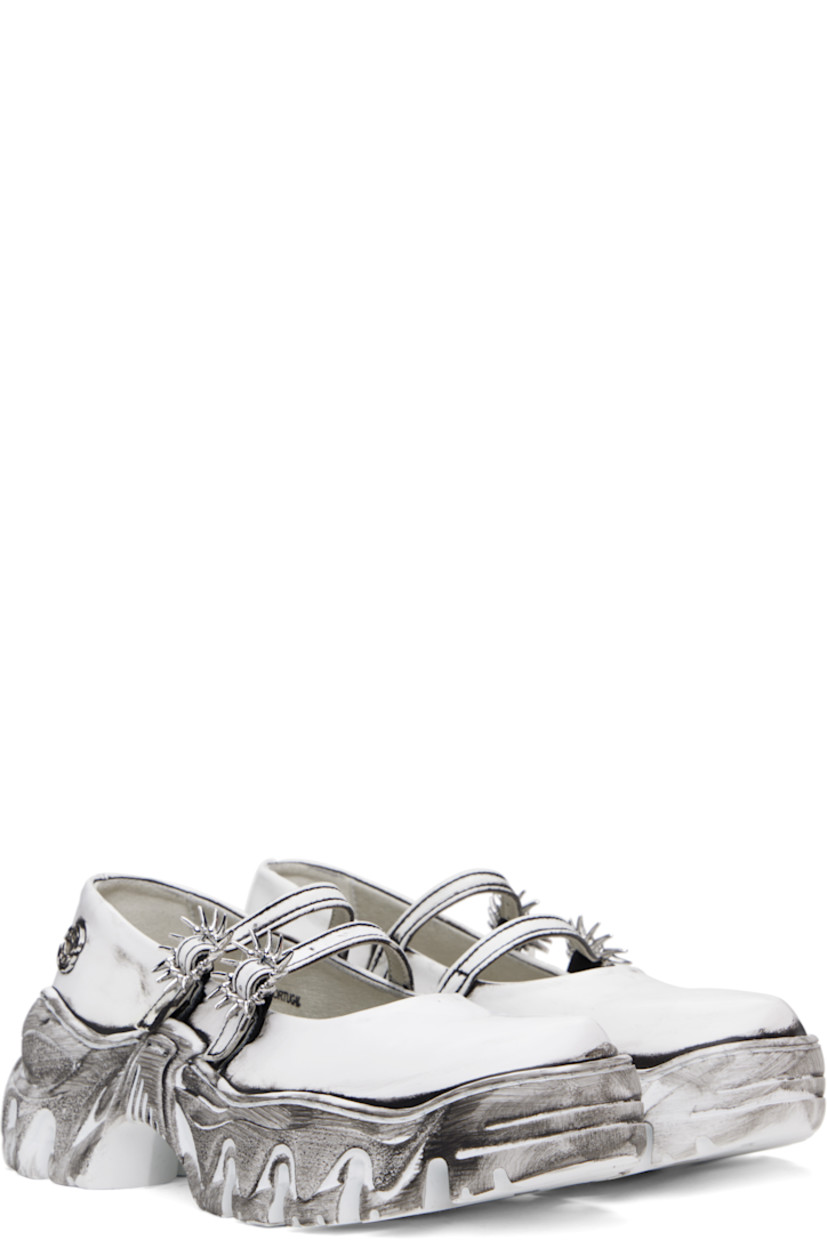 Buffed faux-leather Mary Jane-style loafers in white.

· Bureau Veritas-certified faux-leather
· Smudging throughout
· Partially elasticized pin-buckle straps
· Logo hardware at outer side
· Logo embossed at heel
· Grained faux-leather lining
· Sculptural platform rubber midsole
· Treaded rubber sole
· Silver-tone graphic hardware
· Platform: H1.5"

Supplier color: Quantum