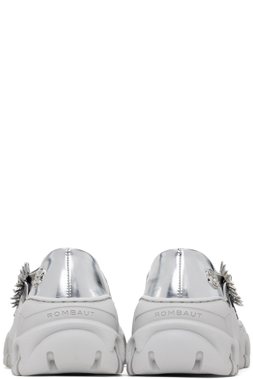 Handcrafted patent faux-leather Mary Jane-style ballerina flats in silver tone.

· Smudging throughout
· Modified pointed toe
· Graphic hardware at pin-buckle straps
· Logo hardware at outer side
· Logo embossed at heel
· Grained faux-leather lining
· Treaded rubber platform sole
· Platform: H1.5"

Available exclusively at SSENSE.

Supplier color: Silver