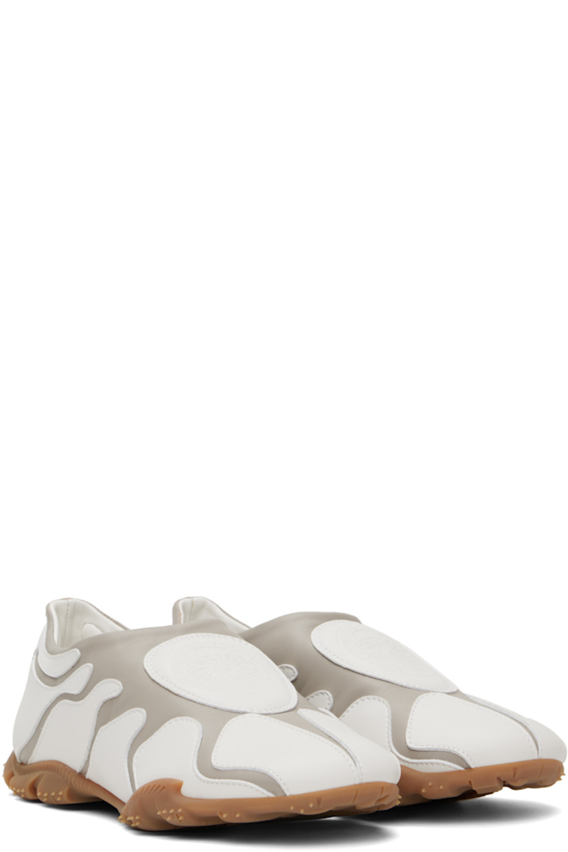 Low-top buffed faux-leather slip-on sneakers in white and gray.

· Faux-leather appliqués throughout
· Padded faux-leather logo patch at vamp 
· Padded collar
· Logo embossed at heel
· Spikes at rubber midsole
· Treaded rubber sole

Supplier color: Grey/White