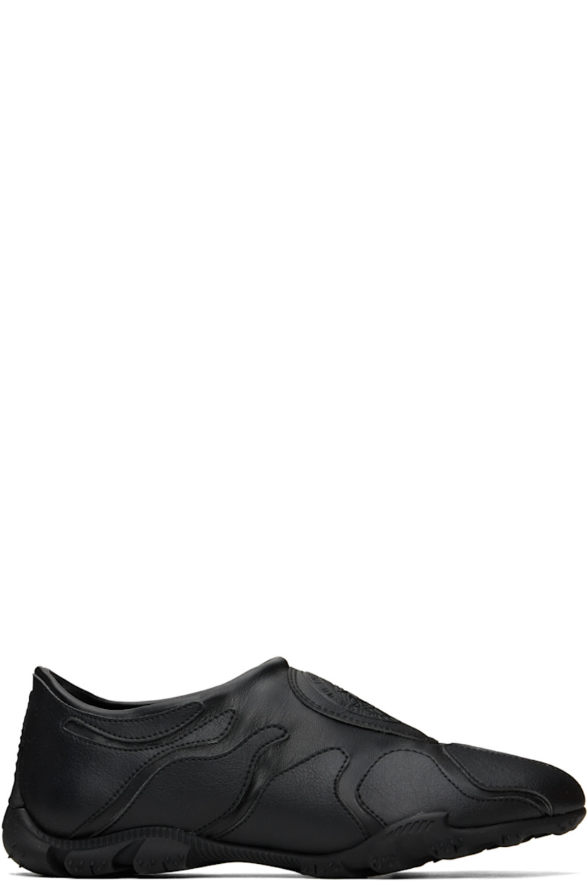 Low-top buffed faux-leather slip-on sneakers in black.

· Faux-leather appliqués throughout
· Padded faux-leather logo patch at vamp 
· Padded collar
· Logo embossed at heel
· Spikes at rubber midsole
· Treaded rubber sole

Supplier color: Black