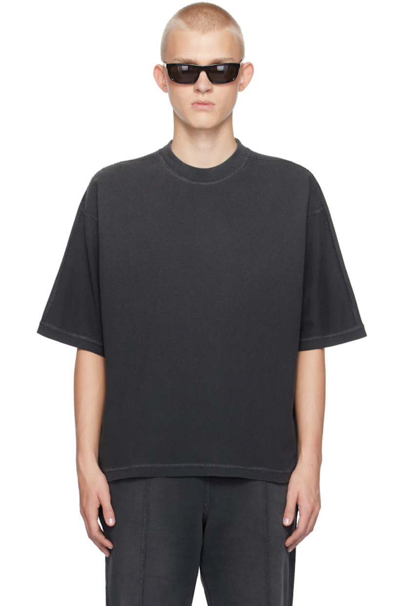 Oversized cotton jersey T-shirt. Exposed seams, fading, and distressing throughout.

· Rib-knit crewneck
· Tennis-tail hem
· Logo flag at side seam
· Dropped shoulders
· Jersey appliqué at back collar

Supplier color: Stained black
