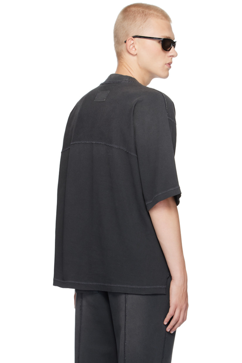 Oversized cotton jersey T-shirt. Exposed seams, fading, and distressing throughout.

· Rib-knit crewneck
· Tennis-tail hem
· Logo flag at side seam
· Dropped shoulders
· Jersey appliqué at back collar

Supplier color: Stained black