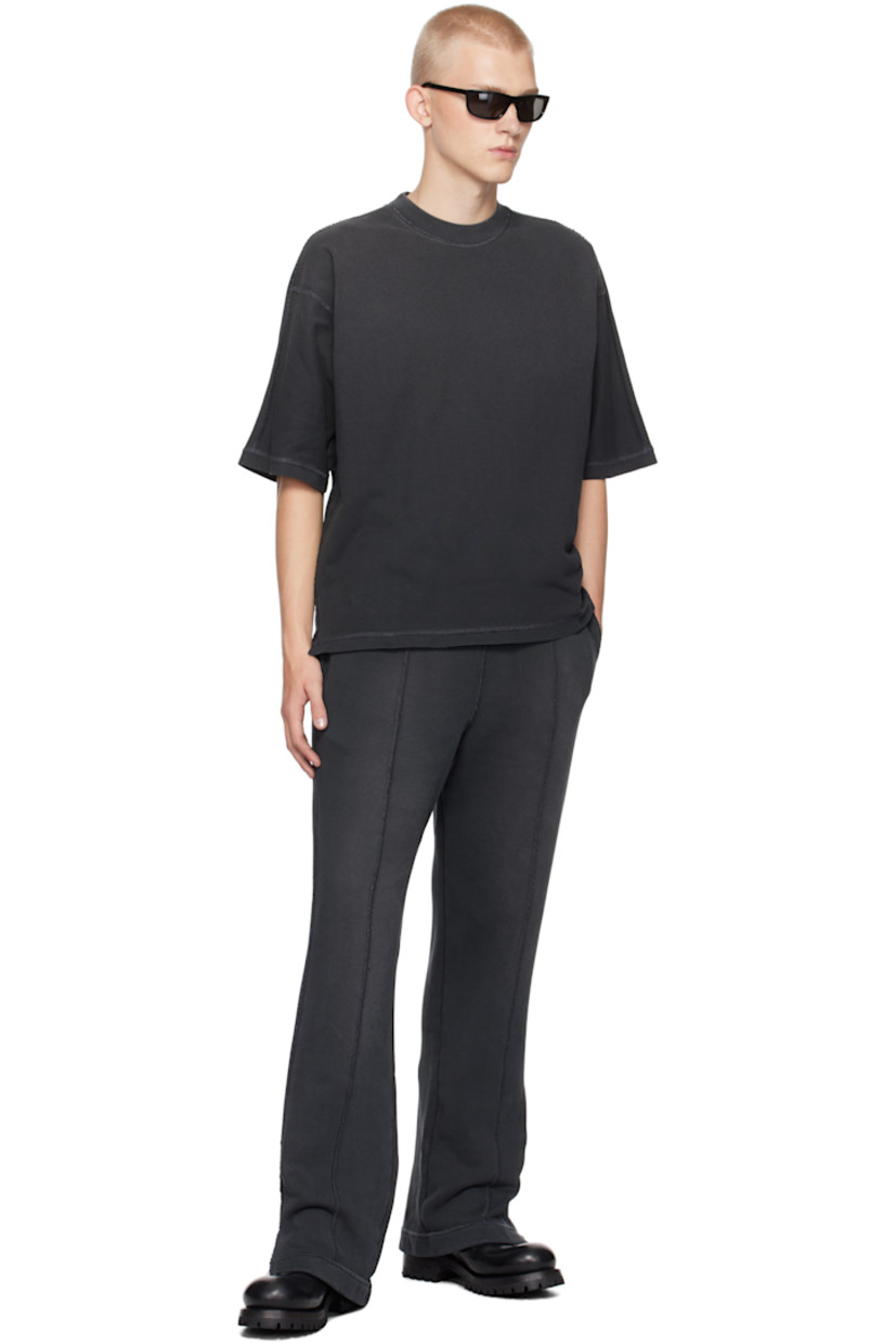 Oversized cotton jersey T-shirt. Exposed seams, fading, and distressing throughout.

· Rib-knit crewneck
· Tennis-tail hem
· Logo flag at side seam
· Dropped shoulders
· Jersey appliqué at back collar

Supplier color: Stained black