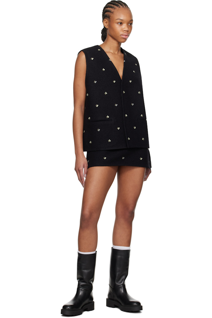 Virgin wool melton miniskirt. Embroidered floral pattern throughout.

· Concealed zip closure at side
· Vented side seam
· Darts at back
· Unlined

Supplier color: Black flowers felted