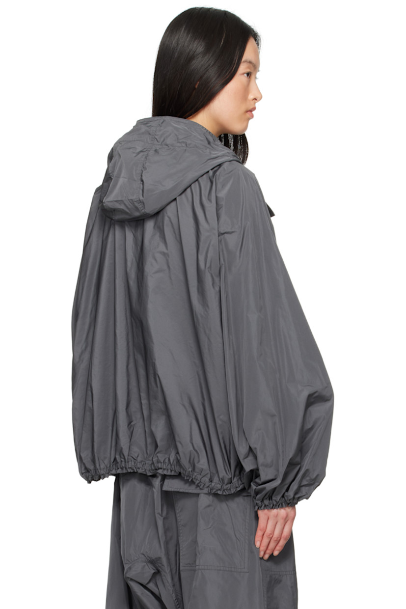 Polyester taffeta jacket.

· Bungee-style drawstring at hood 
· Zip closure
· Zip pockets
· Elasticized hem and cuffs
· Unlined 

Supplier color: Iron