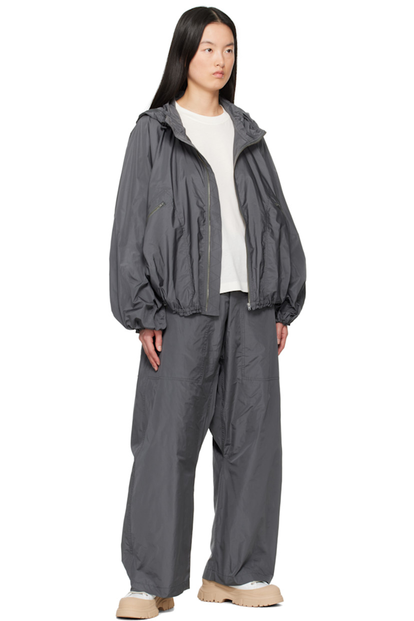 Polyester taffeta jacket.

· Bungee-style drawstring at hood 
· Zip closure
· Zip pockets
· Elasticized hem and cuffs
· Unlined 

Supplier color: Iron
