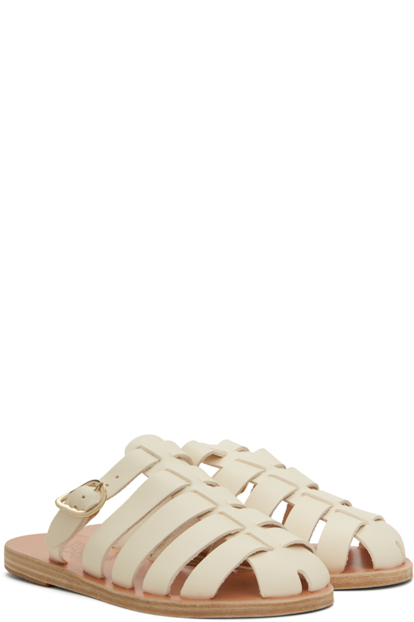 Handcrafted chemical-free buffed leather sandals in off-white.

· Cutouts throughout
· Pin-buckle strap at vamp
· Logo embossed at footbed
· Leather sole with rubber injection

Supplier color: Off white
