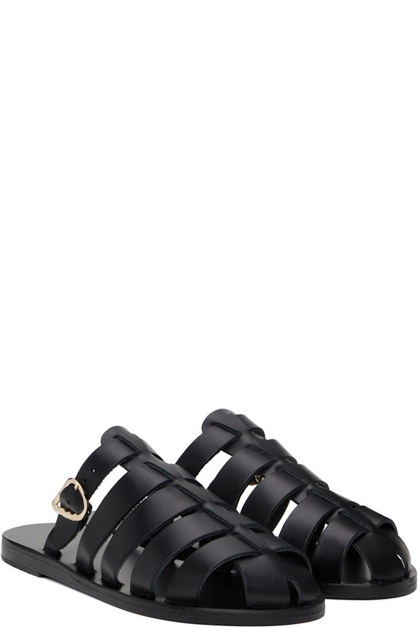 Handcrafted chemical-free buffed leather sandals in black.

· Cutouts throughout
· Pin-buckle strap at vamp
· Logo embossed at footbed
· Leather sole with rubber injection

Supplier color: Black