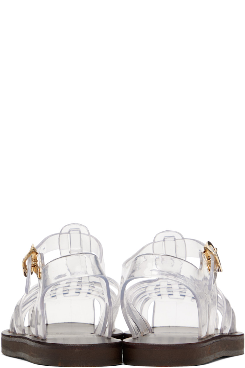Handcrafted transparent vinyl flat sandals.

· Cutouts throughout
· Logo hardware at pin-buckle ankle strap
· Hand-stitched stacked leather midsole
· Logo-embossed rubber sole

Supplier color: Clear