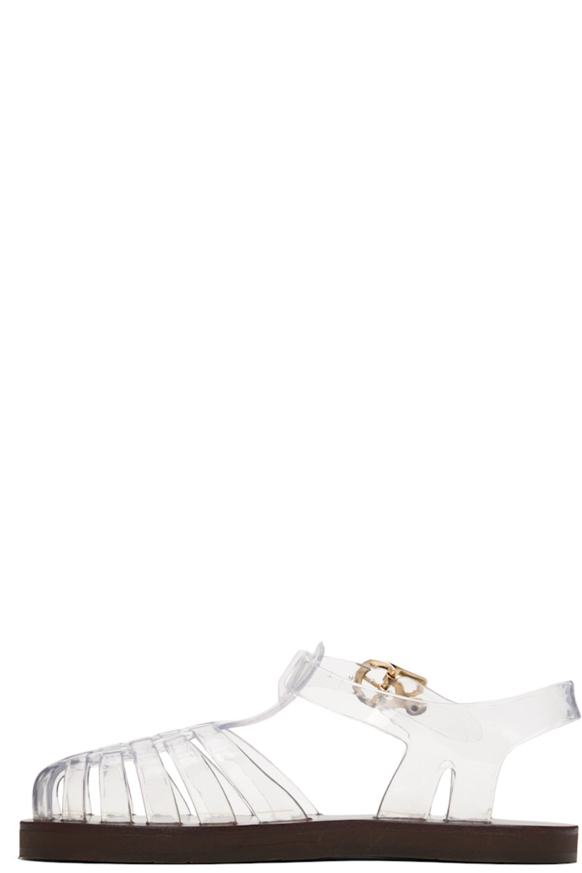 Handcrafted transparent vinyl flat sandals.

· Cutouts throughout
· Logo hardware at pin-buckle ankle strap
· Hand-stitched stacked leather midsole
· Logo-embossed rubber sole

Supplier color: Clear