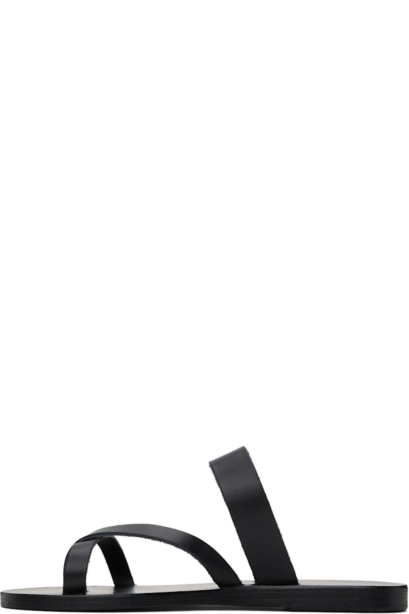Handcrafted chemical-free buffed leather flat sandals in black.

· Raw edges throughout
· Open toe
· Fixed criss-crossing toe strap
· Logo embossed at leather footbed
· Textured rubber heel
· Leather sole

Supplier color: Black