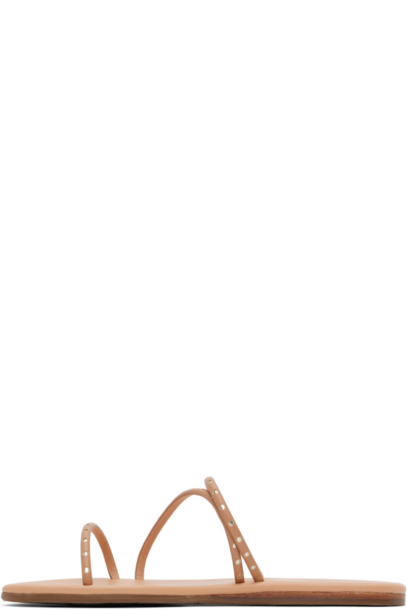 Handcrafted buffed faux-leather flat sandals in beige

· Open toe
· Silver-tone cutouts at straps
· Logo embossed at padded footbed
· Leather midsole
· Treaded rubber sole

Supplier color: Natural/Platinum