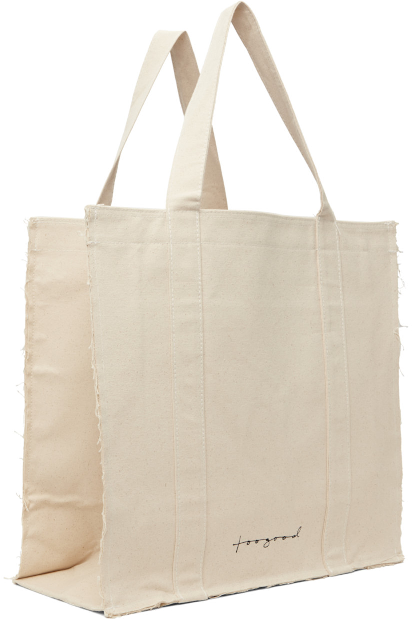 Nep cotton canvas tote in beige.

· Frayed edges throughout
· Fixed shoulder straps
· Logo printed at face
· Press-stud closure
· Zip pocket at interior
· Laptop compartment
· H17" x W18" x D8"

Supplier color: Raw