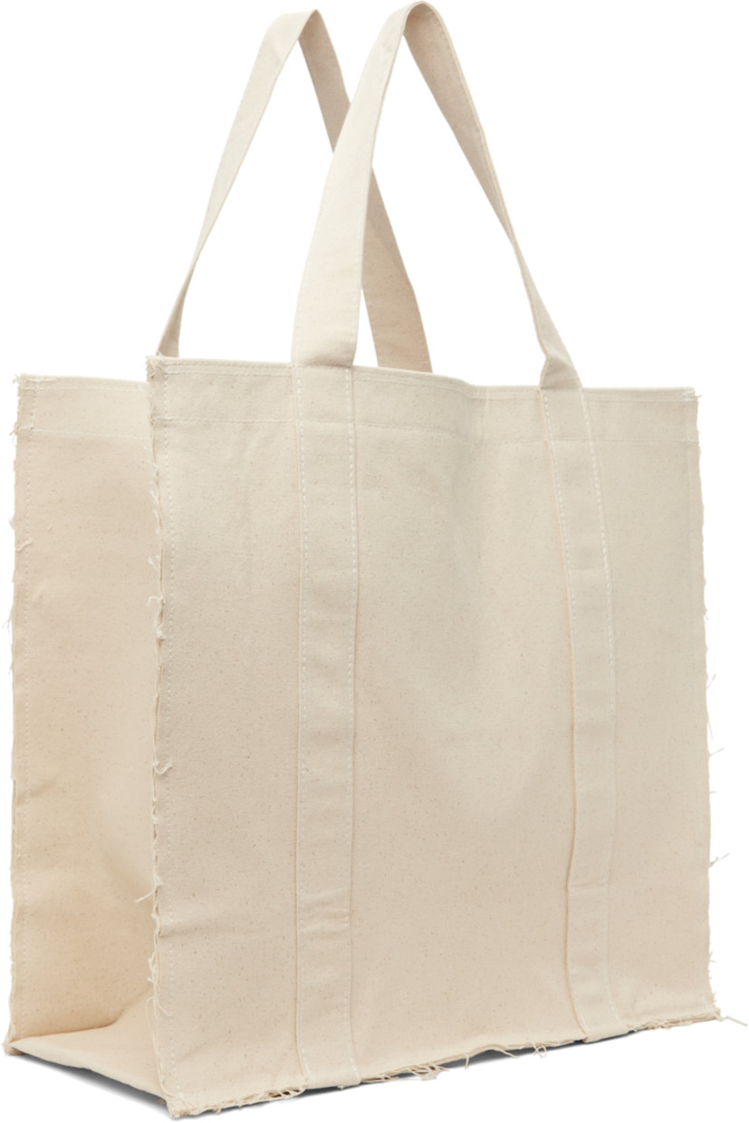 Nep cotton canvas tote in beige.

· Frayed edges throughout
· Fixed shoulder straps
· Logo printed at face
· Press-stud closure
· Zip pocket at interior
· Laptop compartment
· H17" x W18" x D8"

Supplier color: Raw