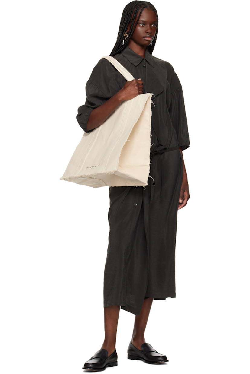 Nep cotton canvas tote in beige.

· Frayed edges throughout
· Fixed shoulder straps
· Logo printed at face
· Press-stud closure
· Zip pocket at interior
· Laptop compartment
· H17" x W18" x D8"

Supplier color: Raw