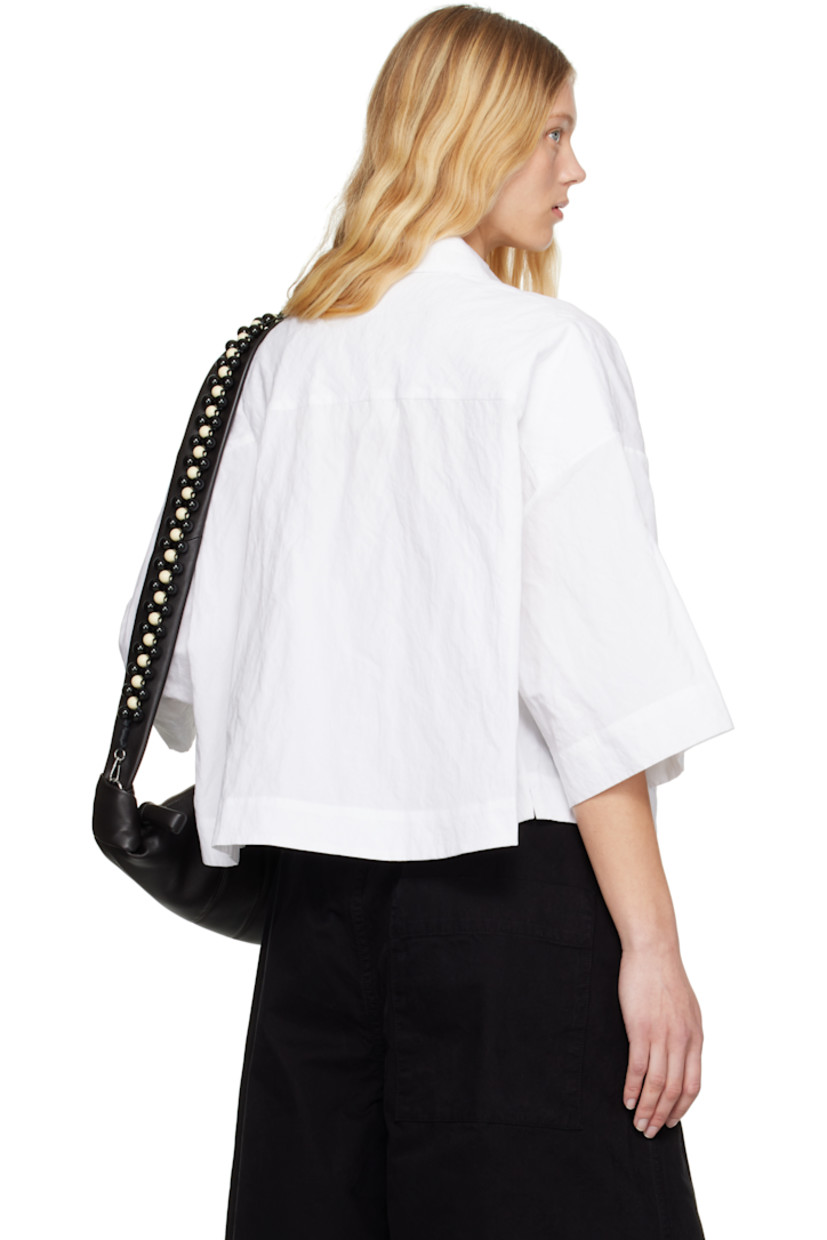 Boxy-fit crinkled cotton-blend poplin shirt.

· Spread collar
· Button closure
· Cropped hem
· Vented side seams
· Dropped shoulders

Supplier color: Chalk