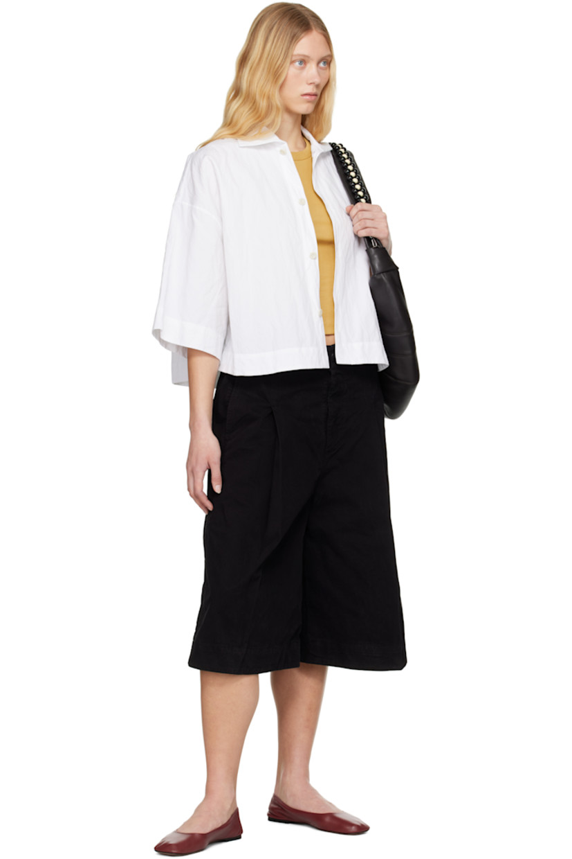 Boxy-fit crinkled cotton-blend poplin shirt.

· Spread collar
· Button closure
· Cropped hem
· Vented side seams
· Dropped shoulders

Supplier color: Chalk