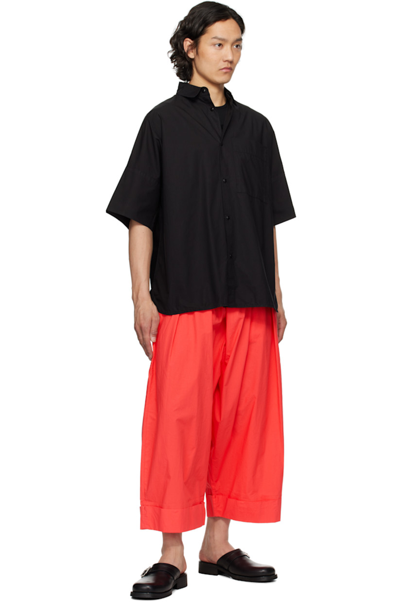 Wide-leg cotton poplin trousers.

· Lightweight and garment-dyed
· Concealed drawstring at elasticized waistband
· Three-pocket styling
· Pleats at front
· Cropped legs
· Rolled cuffs

Supplier color: Tomato