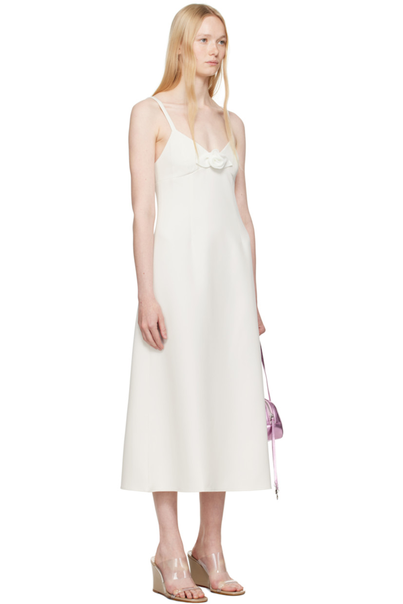 Stretch polyester broadcloth midi dress. 

· V-neck
· Floral appliqué at chest
· Darts at front
· Flared hem
· Concealed zip closure at side
· Elasticized trim at low back
· Partial viscose twill lining

Supplier color: Ivory