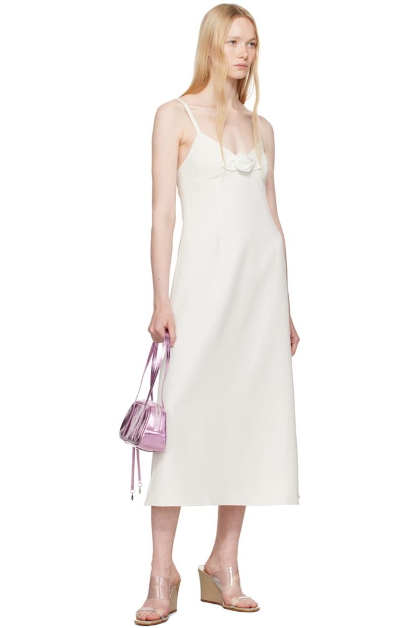 Stretch polyester broadcloth midi dress. 

· V-neck
· Floral appliqué at chest
· Darts at front
· Flared hem
· Concealed zip closure at side
· Elasticized trim at low back
· Partial viscose twill lining

Supplier color: Ivory
